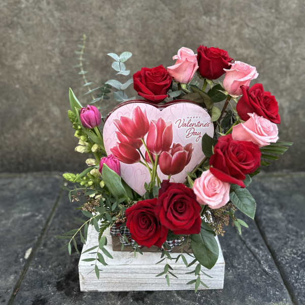 Heart-shaped Valentine bouquet with red and pink roses and tulips