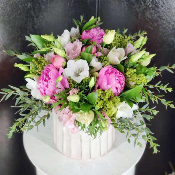 Pink and white bouquet in a white ribbed vase