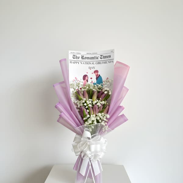 Lavender-wrapped bouquet with pink tulips and white baby's breath