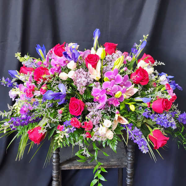 Large mixed bouquet of pink roses, purple orchids, and lilies