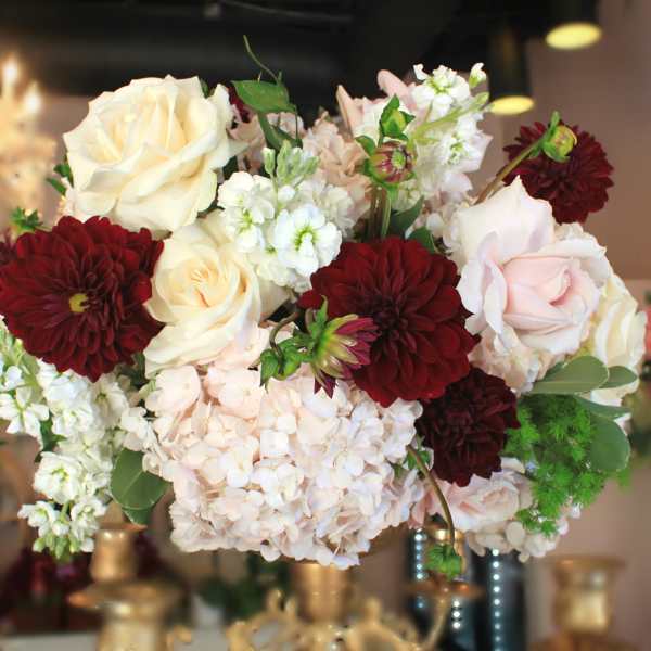 Bouquet of cream roses, burgundy dahlias, and white blooms
