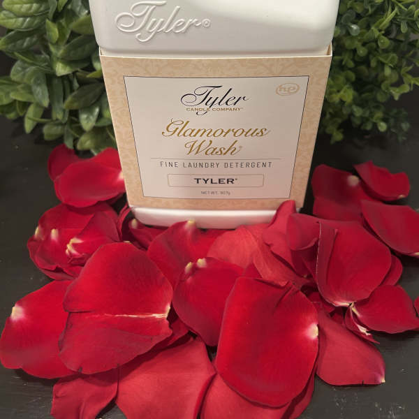 Tyler Glamorous Wash detergent bottle surrounded by red rose petals