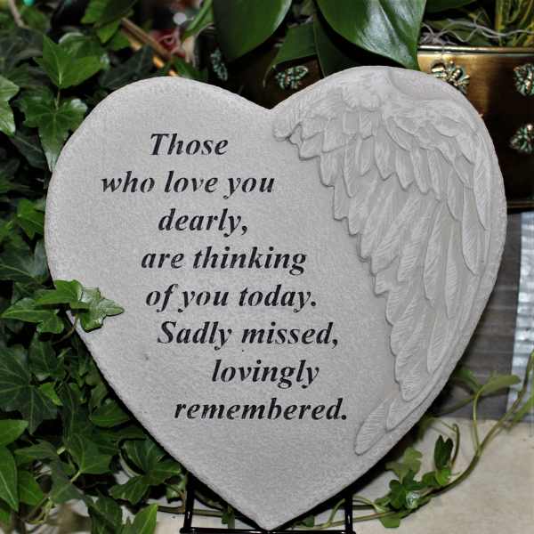 Heart-shaped memorial plaque with angel wing relief and sympathy text