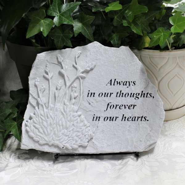 Memorial stone with floral relief and the words "Always in our thoughts, forever in our hearts."