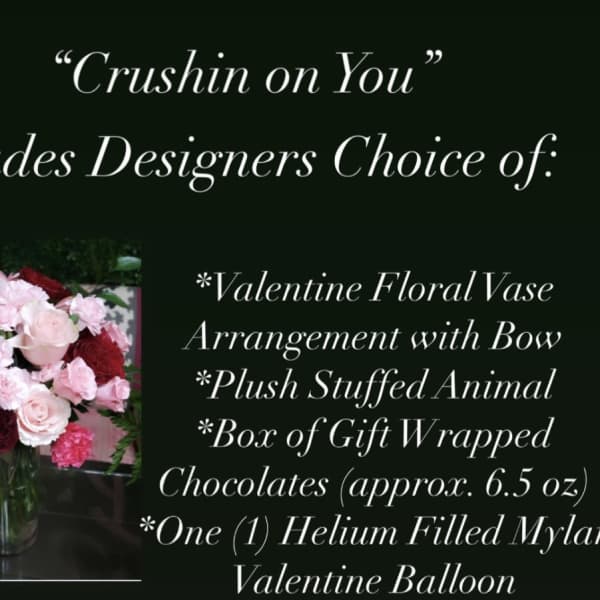 Valentine bouquet in a glass vase with a stuffed animal, chocolates, and a balloon