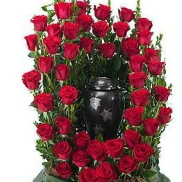 Red roses arranged around a black urn-shaped vase