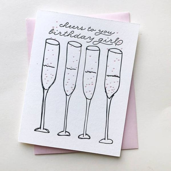 Birthday card with four champagne flutes and handwritten text