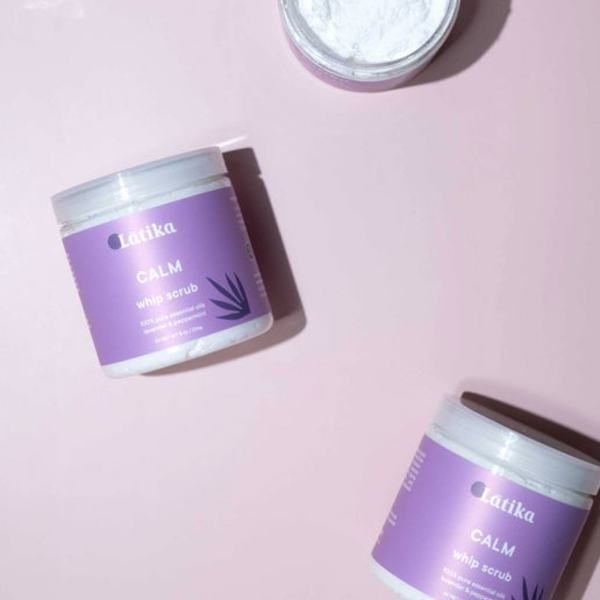 Purple jars of whipped scrub on a pink background