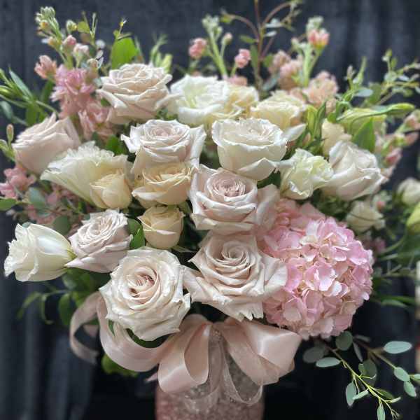 Blush and white roses with pink hydrangea in a pink vase