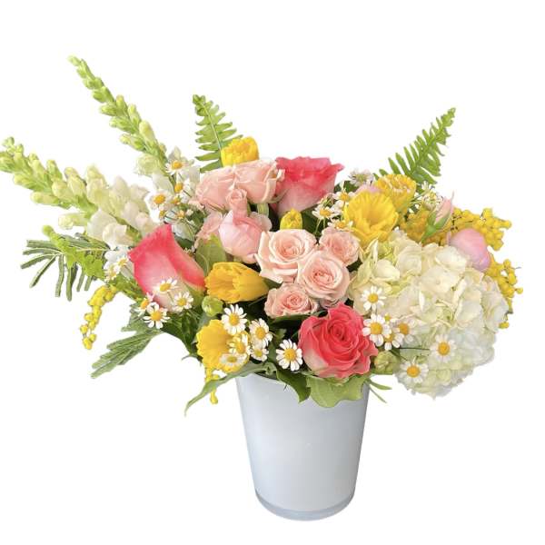 Mixed bouquet of pink and yellow flowers in a white vase