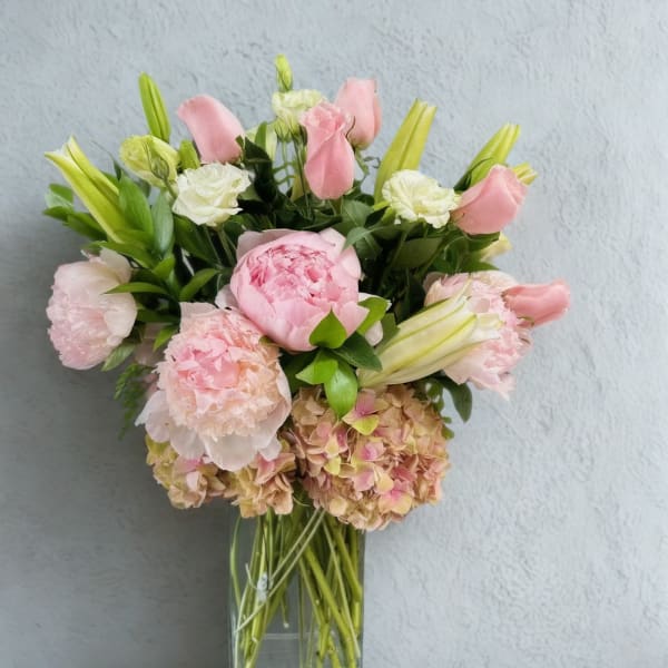 Pink and white bouquet in a clear glass vase