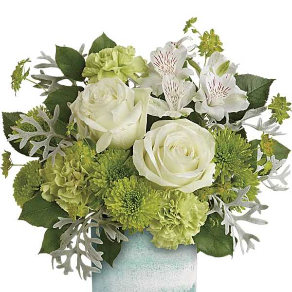 White roses and green flowers in a blue glass vase
