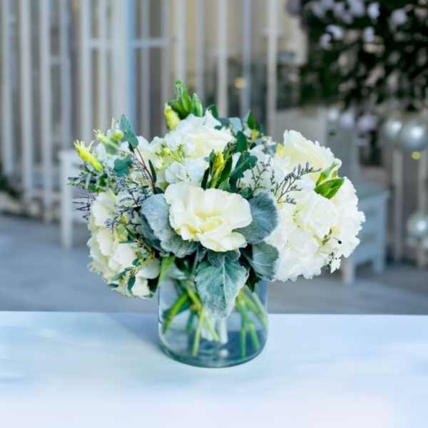 White floral arrangement in a clear glass vase