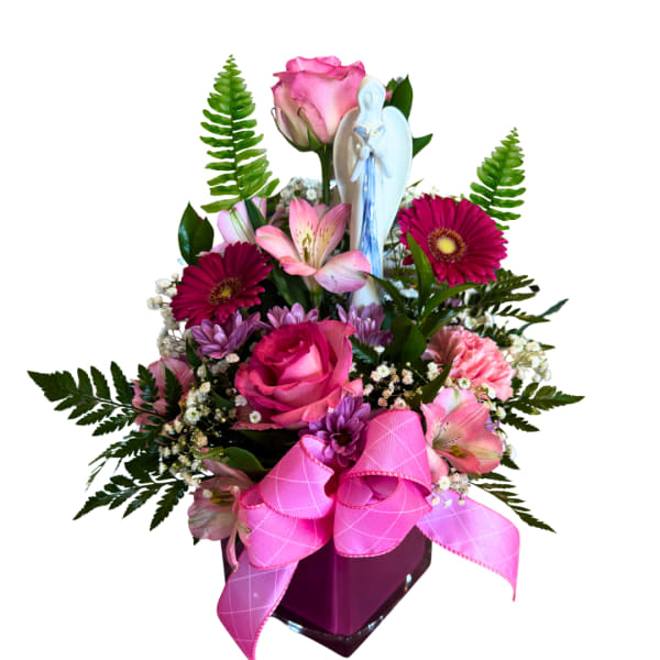 Pink mixed flower arrangement with a small angel figurine in a vase