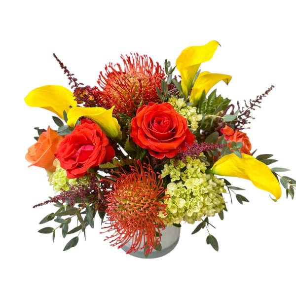 Bouquet of red roses and yellow calla lilies in a vase