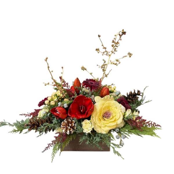Holiday floral arrangement with red and yellow blooms in a wooden container