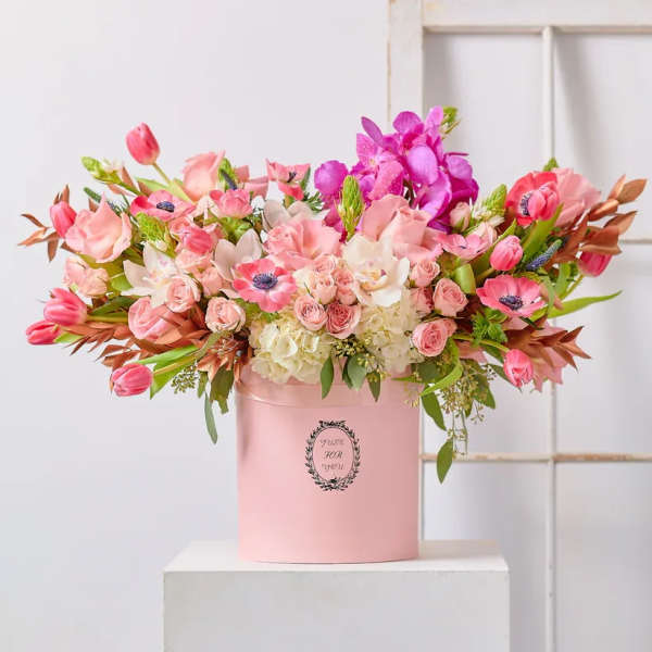 Pink and white mixed flower arrangement in a pink hat box