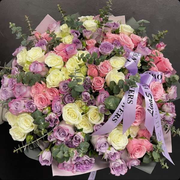 Large bouquet of pink, lavender, and cream roses with eucalyptus