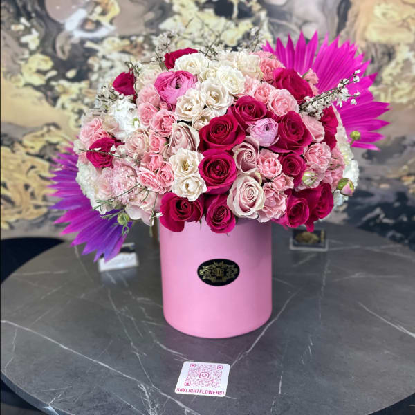 Pink and white rose bouquet in a pink cylindrical box