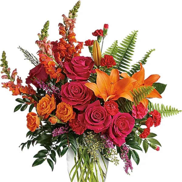 Bright bouquet of roses and orange lilies in a clear glass vase