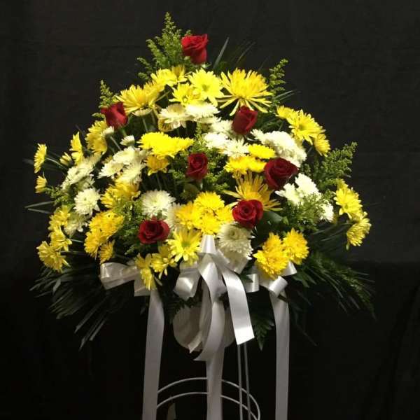Standing floral spray with yellow and white chrysanthemums and red roses