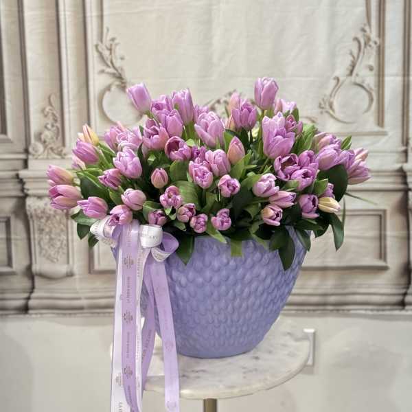 80 lavender tulips in a lavender vase