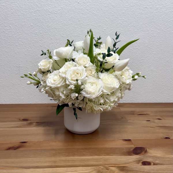 White floral arrangement in a white vase