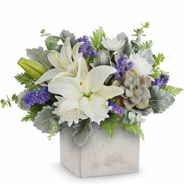 White lilies and purple flowers in a square gray vase