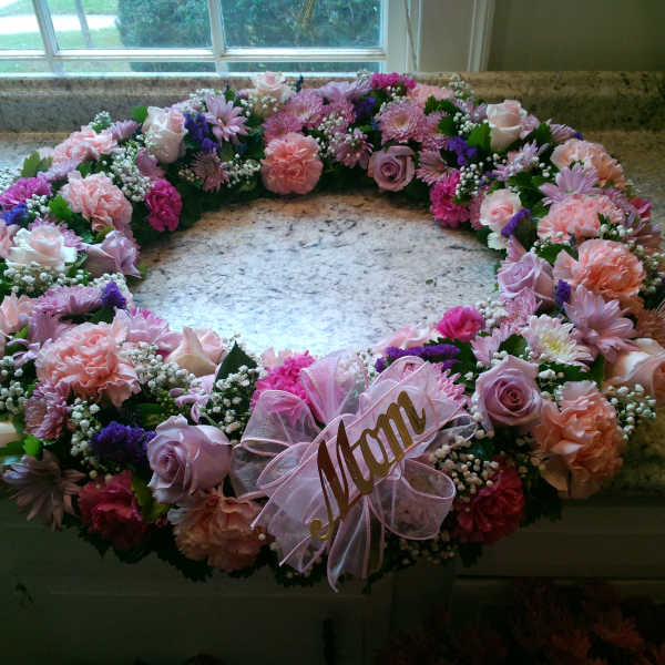 Pink and lavender floral wreath with a ribbon name tag