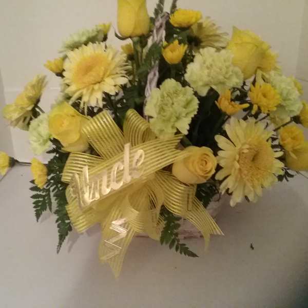 Yellow bouquet with daisies, carnations, and roses tied with a ribbon