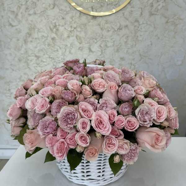 Pink rose bouquet in a white basket vase