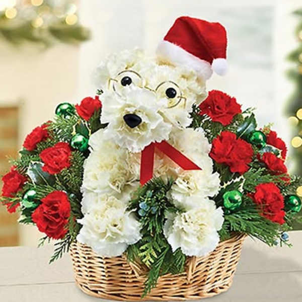White teddy bear floral arrangement in a basket with red roses and a Santa hat