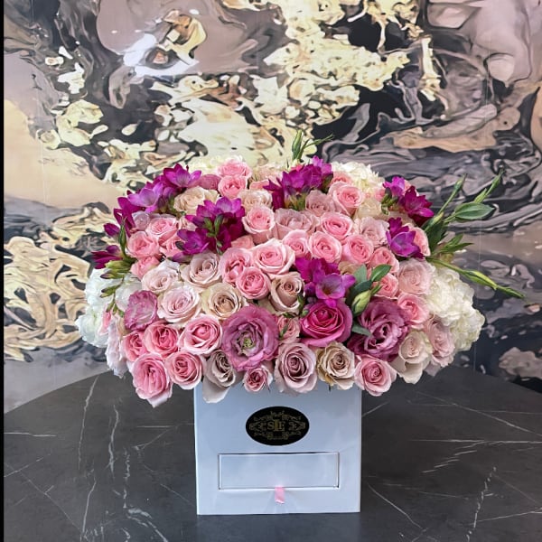 Large bouquet of pink and white roses in a white box