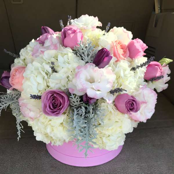 Pink and white bouquet in a round pink box