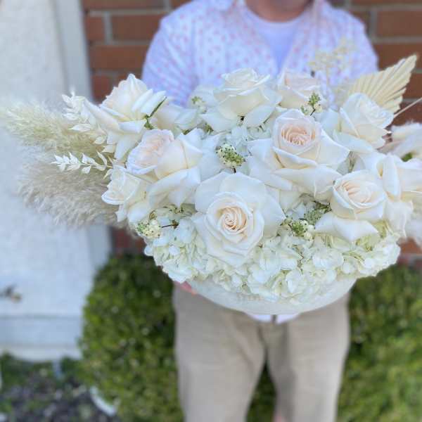 Large white rose bouquet with pale hydrangeas and feathery accents