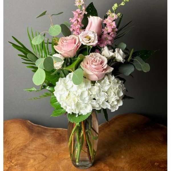 Pink and white floral arrangement in a clear glass vase