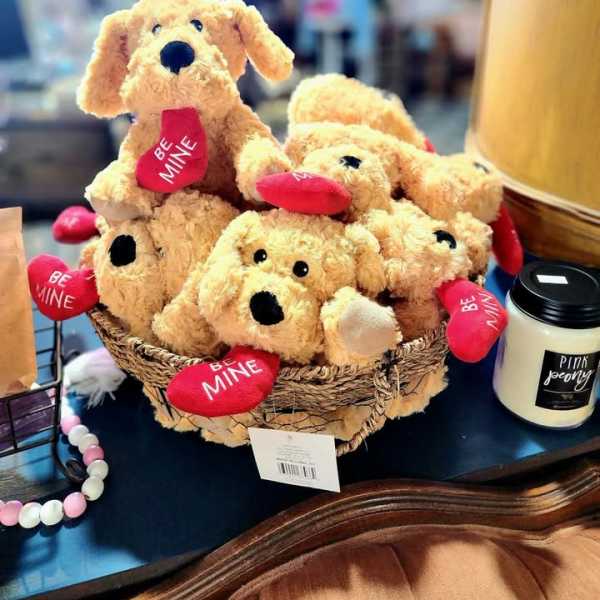 Basket of plush dogs holding red heart tags