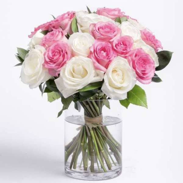 Bouquet of pink and white roses in a clear glass vase