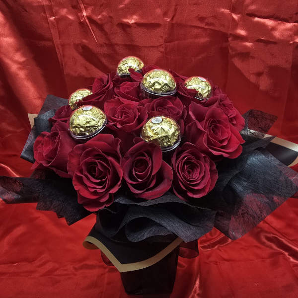 Bouquet of red roses with gold-wrapped chocolates