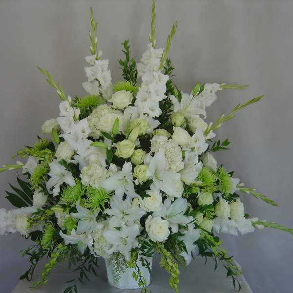 White floral arrangement with lilies and roses in a vase