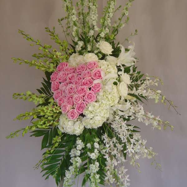 Tall standing floral spray with pink roses and white flowers
