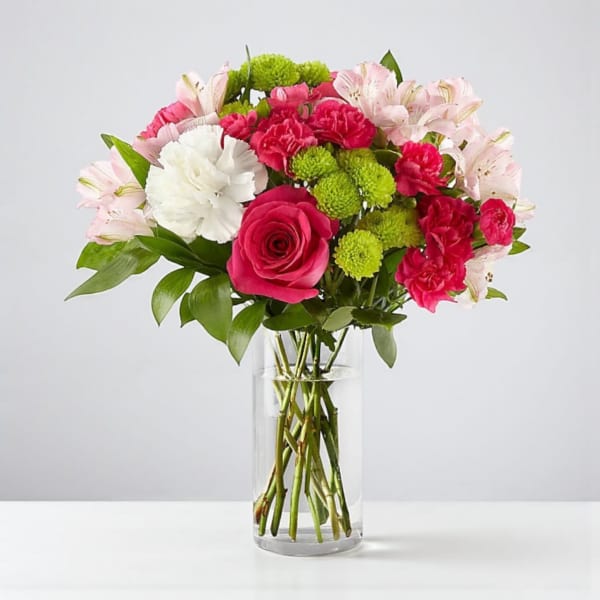 Bouquet of pink and white flowers in a clear glass vase
