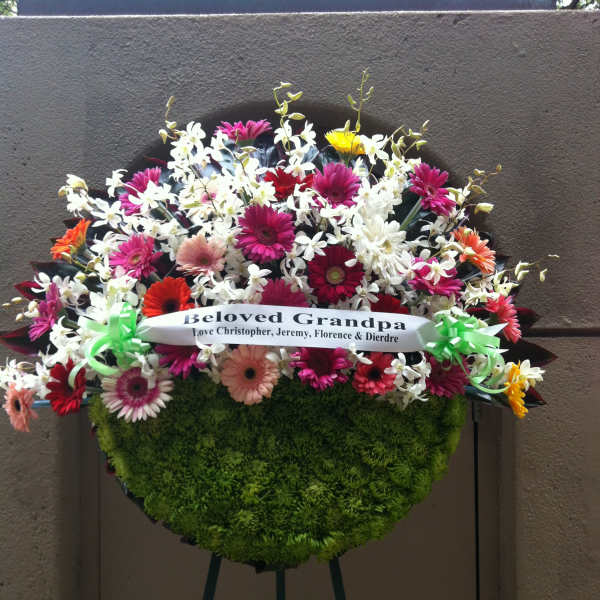 Mix spring flowers and orchids on half moon wreath - F35013