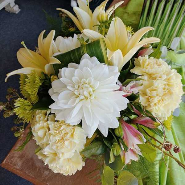 Bouquet of white and pale yellow flowers with pink accents