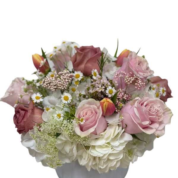 Pink roses and white hydrangeas in a white vase
