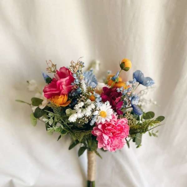 Colorful bouquet with pink, blue, white, and orange flowers