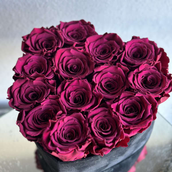 Bouquet of deep pink roses in a black box