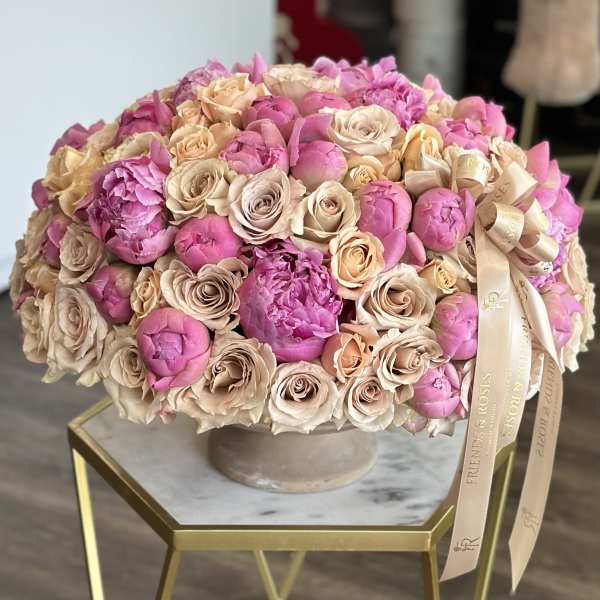 Large bouquet of pink and blush roses in a round vase