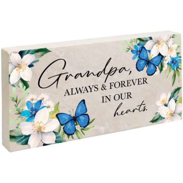 Memorial plaque with flowers and blue butterflies reading "Grandpa, always & forever in our hearts."