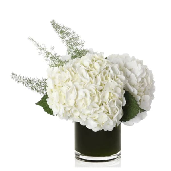 White hydrangea arrangement in a dark glass vase